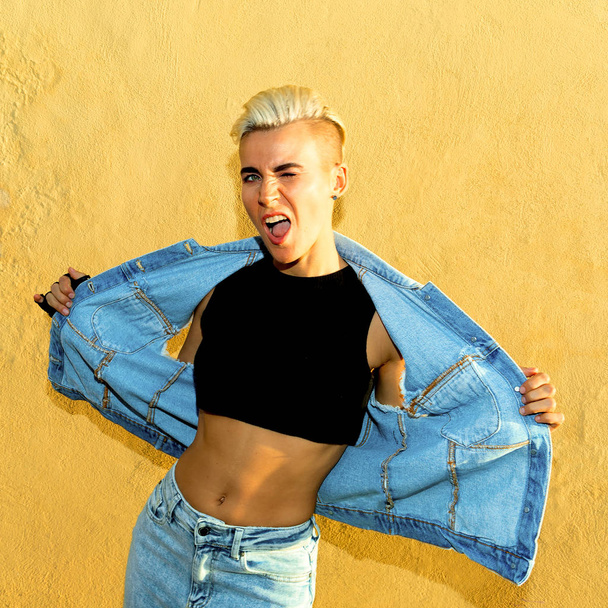 Stylish blonde with short hair in denim clothes in the city - Fotoğraf, Görsel