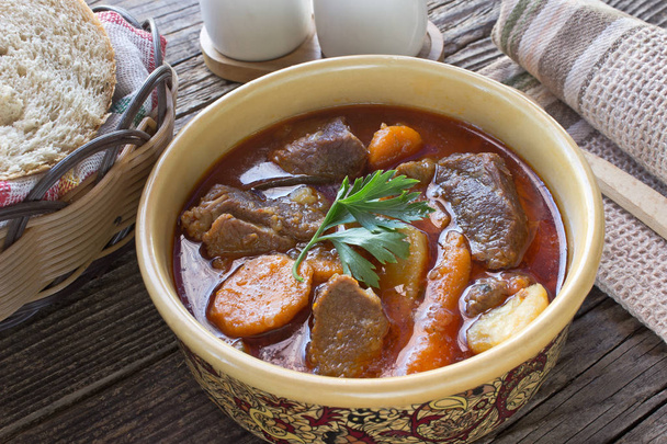 Stew with meat and vegetable in ceramic bowl on table - Photo, Image