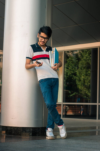 Young smrat student guy with books in hands - Foto, imagen