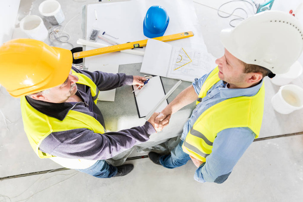 Architect and construction engineer handshake. - Photo, Image