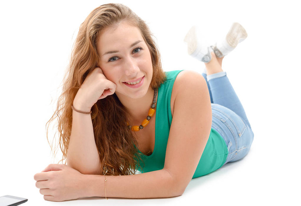 smiling woman in green casual smart clothing, lying on the floor - Foto, Imagen