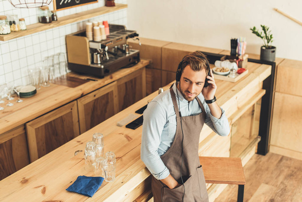 barista in headphones in cafe - Photo, Image