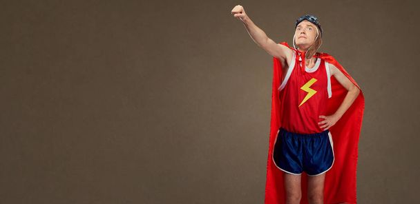 Funny funny cheerful man in a superhero costume in sports clothe - Foto, afbeelding