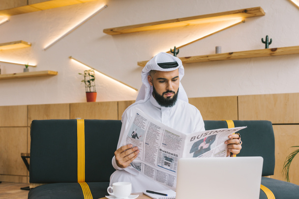 muslim businessman reading newspaper - 写真・画像