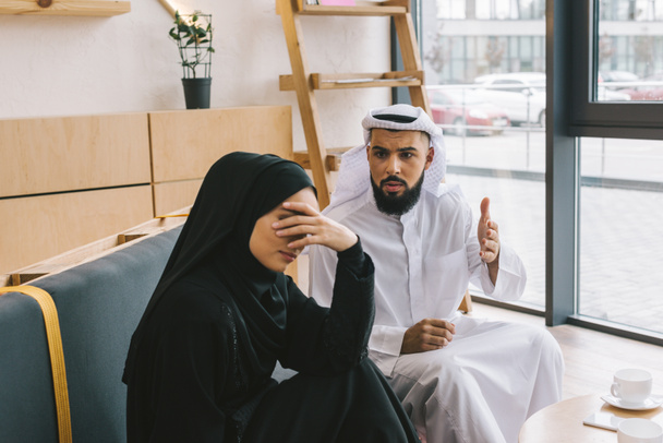 muslim couple having argument in cafe - Фото, изображение