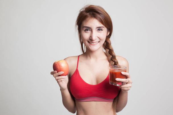 Beautiful healthy Asian girl with tomato juice and apple. - Fotografie, Obrázek