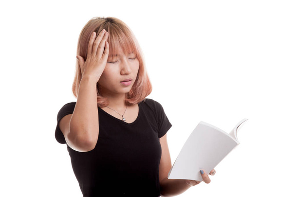 Young Asian woman got headache read a book. - Фото, изображение