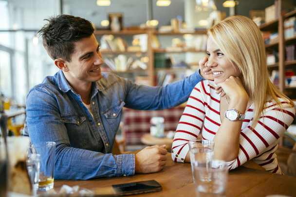couple in love flirting in restaurant - Фото, изображение