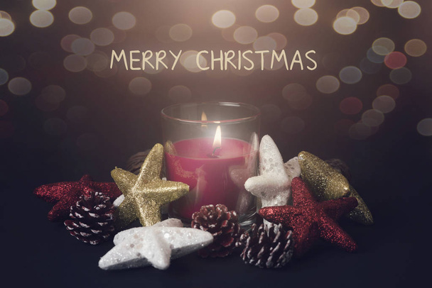 Merry Christmas. Candle next to christmas ornaments - Foto, Imagem