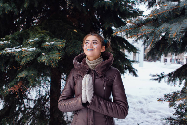 Winter portrait of a girl with stars on face - Photo, Image