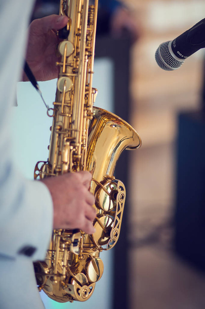 A man play with saxophone - Φωτογραφία, εικόνα