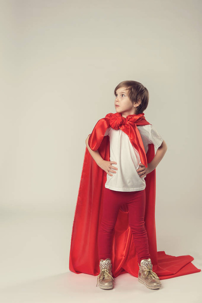 Female superhero kid posing in studio - Foto, imagen
