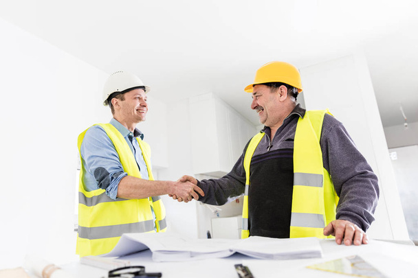 Architect and construction engineer handshake. - Photo, Image