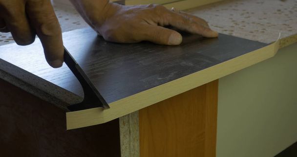 Furniture factory. Manual trim over the ends, closeup. - Photo, image