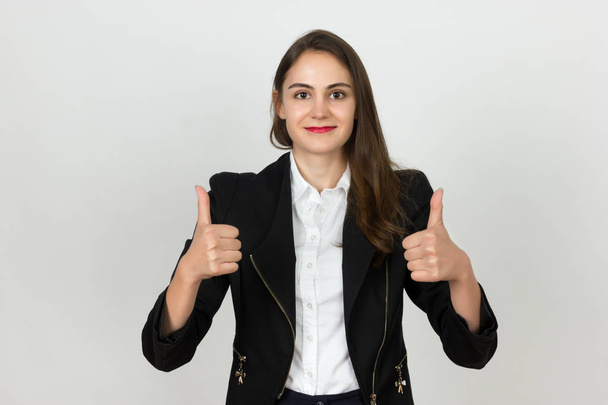 Thumb up. Happy young businesswoman isolated on gray background. - Φωτογραφία, εικόνα