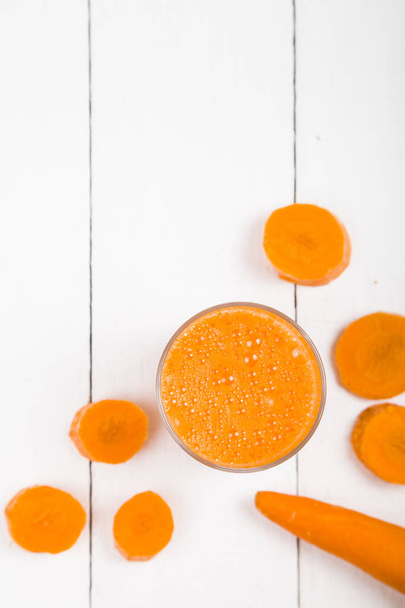 Carrot juice on a wooden table - Photo, image