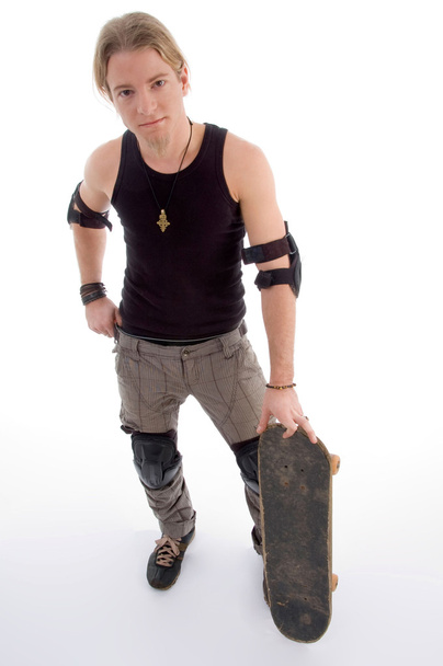 Handsome guy standing with skateboard - 写真・画像