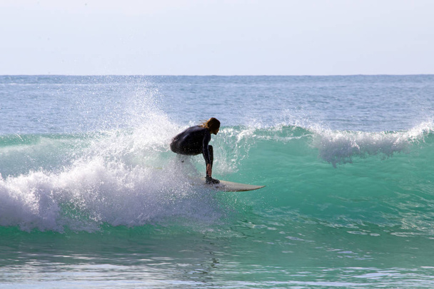 Surfista surfando as ondas no Mar do Caribe
 - Foto, Imagem