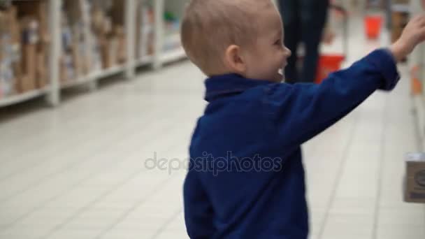 child buys baby food in a store or supermarket. - Metraje, vídeo