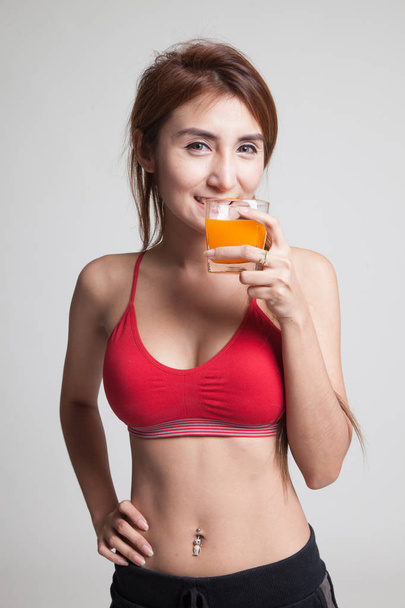 Beautiful Asian healthy girl drinking  orange juice. - Zdjęcie, obraz