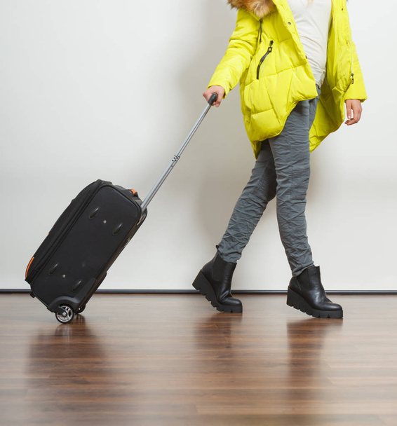 Woman in warm jacket with suitcase. - Zdjęcie, obraz