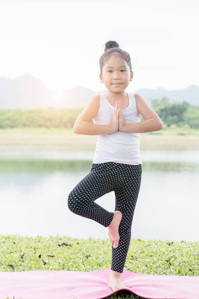 Little cute asian girl practicing yoga pose  - Photo, Image