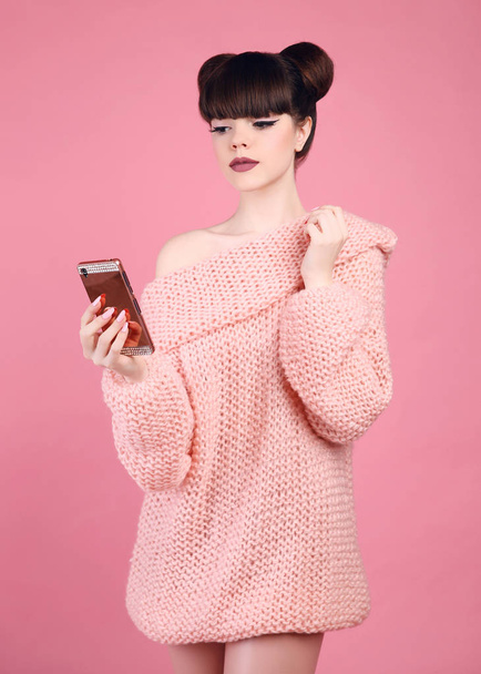 Brunette holding mobile phone. Fashion studio teen look style ov - Φωτογραφία, εικόνα