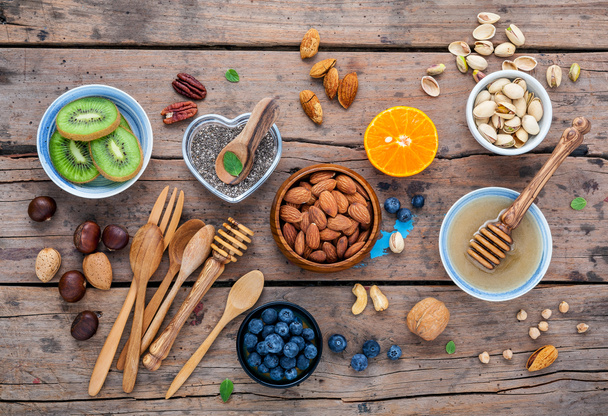 Ingredients for a healthy foods background, nuts, honey, berries - Photo, Image