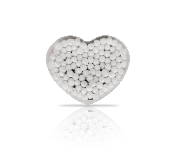 Brotes de algodón en un recipiente de plástico en forma de corazón
 - Foto, Imagen