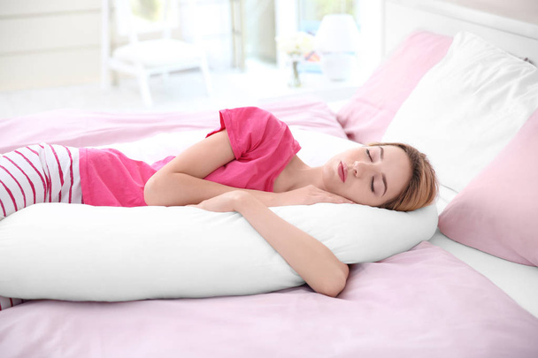 woman sleeping with body pillow - Photo, Image