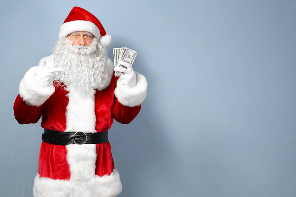 Santa Claus holding money  - Foto, Bild