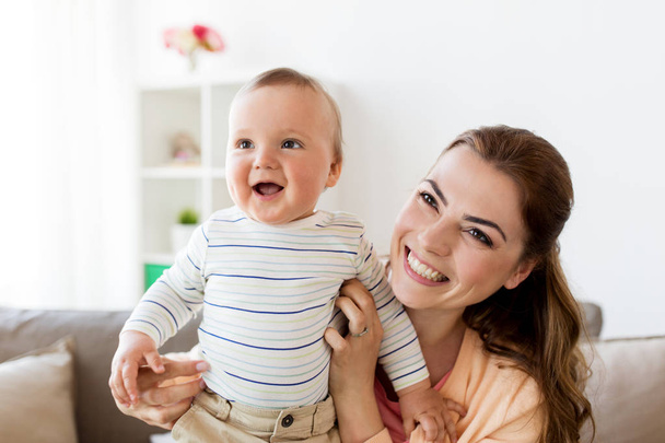happy young mother with little baby at home - Foto, imagen