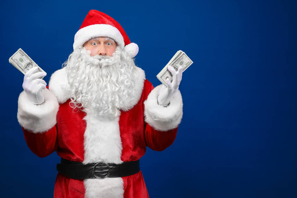 Santa Claus holding money  - Фото, изображение