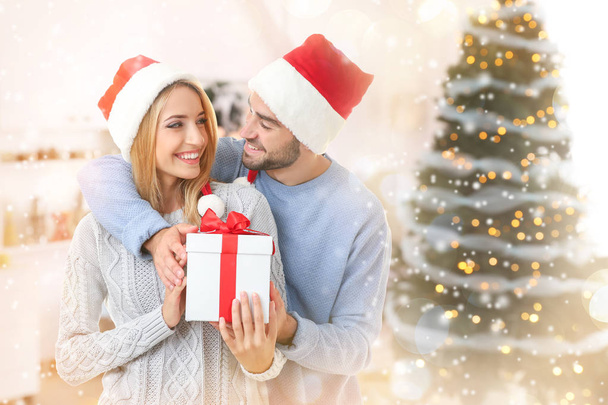 Happy couple in Santa hats   - Фото, изображение