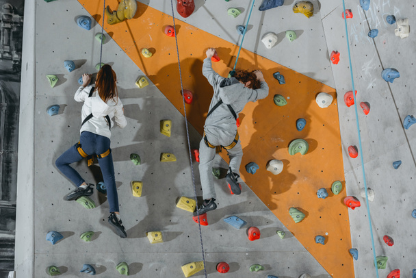 two little kids climbing wall with grips - Photo, Image