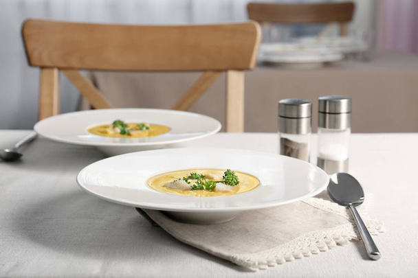 Plates with broccoli cheddar soup  - Photo, image