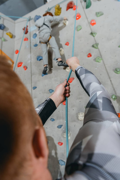 Little boy climbing wall with grips - Photo, Image