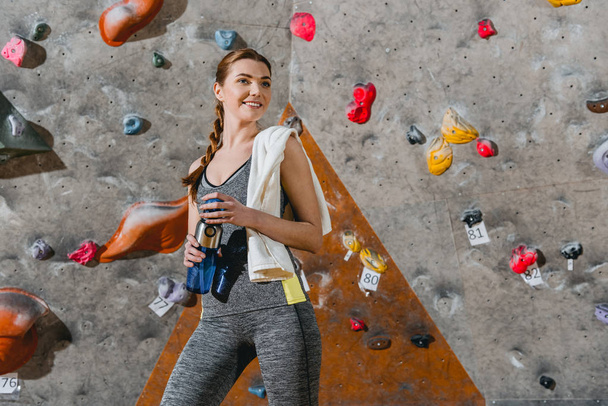 Mujer deportiva frente a la pared de escalada
 - Foto, imagen