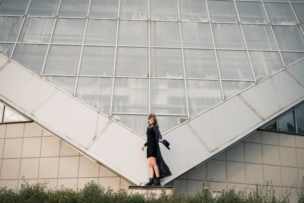 Young girl against the metal architecture  - 写真・画像