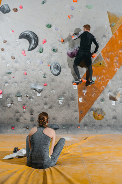 young man climbing wall with grips - Photo, Image