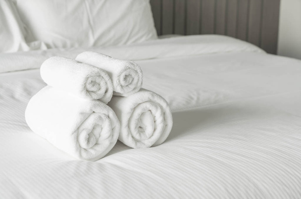White towel on bed decoration in bedroom interior  - Foto, Imagen