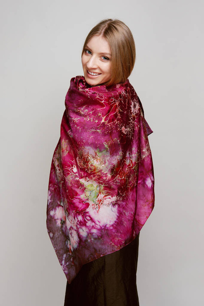 Portrait of beautiful smiling girl with colorful silk shawl - Foto, afbeelding