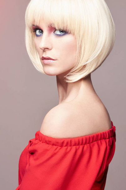 blond woman with bob hairstyle,make-up,red dress - Zdjęcie, obraz