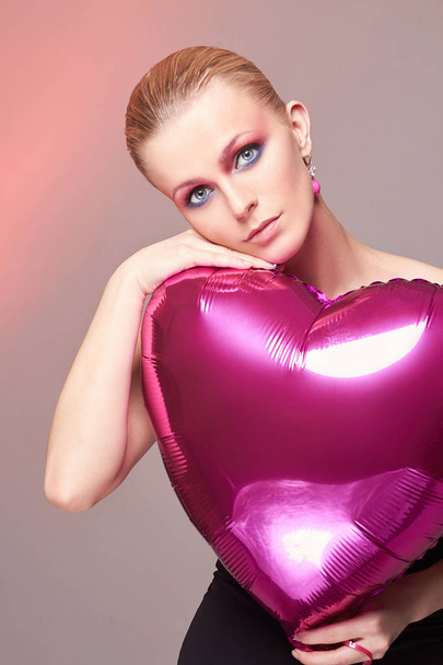 lovely woman with heart and colorful male-up - Photo, Image