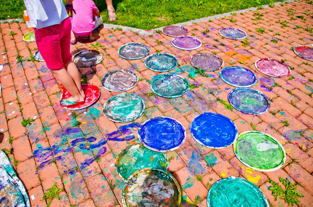 feet of children full of colorful gouache - Photo, Image