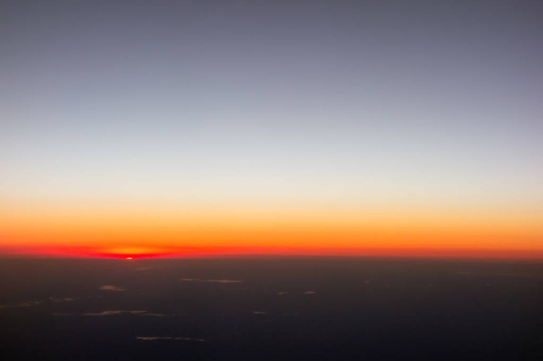 beautiful sunset view from an airplane over land - Photo, Image