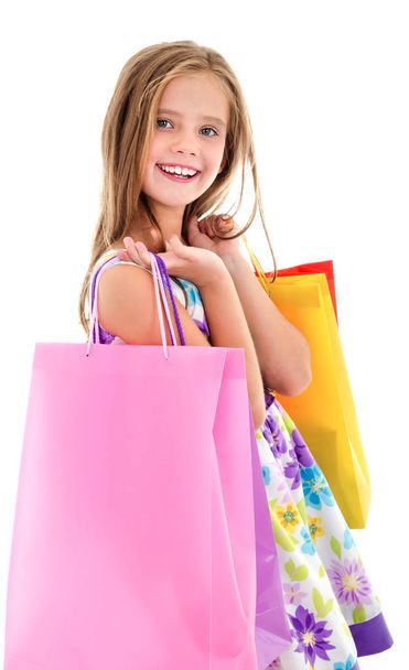 Adorable little girl child holding shopping colorful paper bags  - Foto, imagen