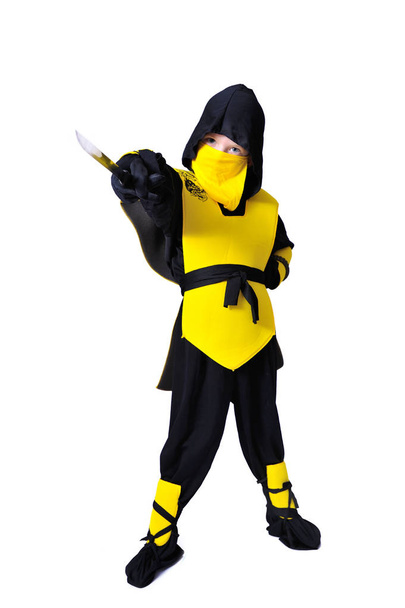 The seven-years old boy in black and yellow ninja suit with a ho - Photo, Image