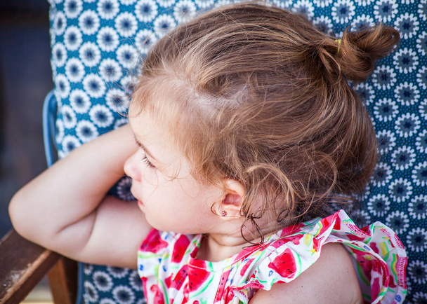 Милая маленькая девочка портрет в клубничном платье и глядя в сторону
 - Фото, изображение