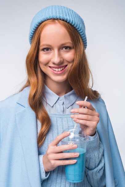girl in blue with beverage - Photo, Image